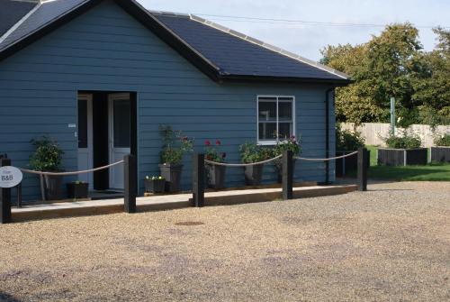 a blue house with a rope in front of it at Tirah Guest House in Aldeburgh