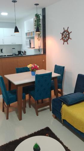 a kitchen and dining room with a table and chairs at Golden Lake Apart Hotel Arraial do Cabo RJ A&J 2 in Arraial do Cabo