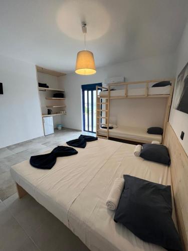 a large bed in a room with two bunk beds at Ocean Palace in Prasonisi