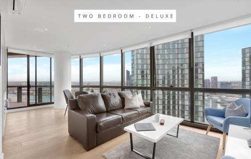 a living room with a couch and a table at Melbourne Lifestyle Apartments - Best Views on Collins in Melbourne