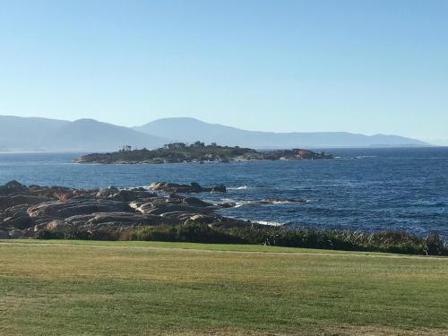 a large body of water with a group of rocks at OceanFront - Absolute Waterfront in Bicheno