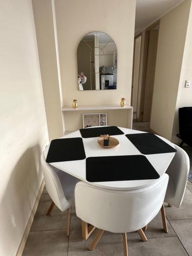 a black and white table and chairs in a room at Departamento linares in Linares