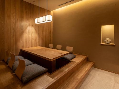 a dining room with a wooden table and chairs at SOKI ATAMI in Atami