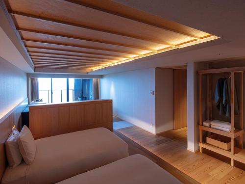 a living room with a couch and a window at SOKI ATAMI in Atami