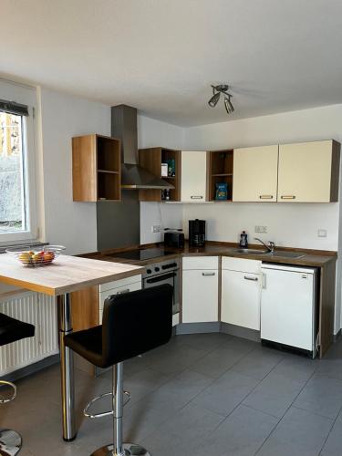 a kitchen with white cabinets and a counter top at Schönes Apartment mit Terrasse - Privatvermietung in Waldstetten