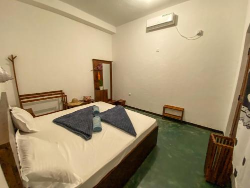 a bedroom with a bed and a pool of water at Surfers Park Arugambay in Arugam Bay