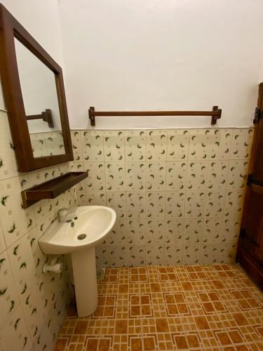 a bathroom with a sink and a mirror at Surfers Park Arugambay in Arugam Bay