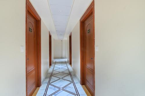 a hallway with two wooden doors and a ladder at Trim Boutique Parkota Haveli in Jaipur
