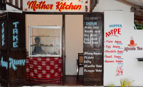 a store entrance with a machine kitchen and a sign at Surfers Park Arugambay in Arugam Bay