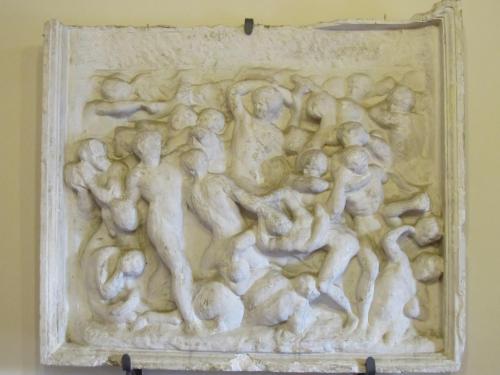 a bas relief of a group of people at Hotel Il Castello in Certaldo