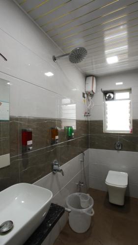 a bathroom with a sink and a toilet at Aum Villa Pet Friendly in Karjat