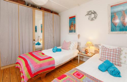 a small bedroom with two beds and a table at The Cherries in York