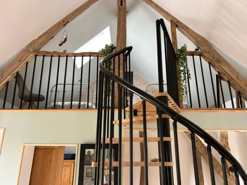 a staircase with black railings in a house at Le refuge côtier in Rue