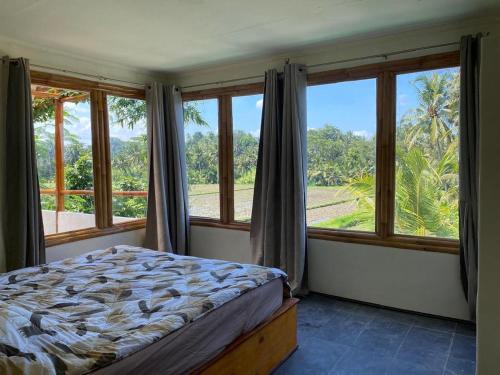 a bedroom with a bed and large windows at 4 bedroom villa aline in Marga