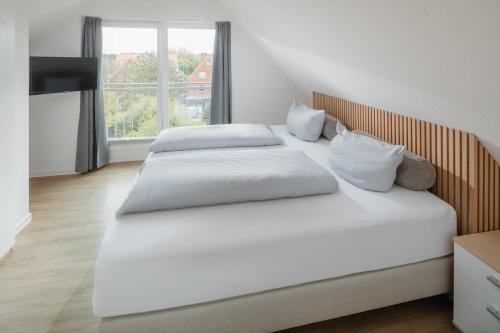 Postel nebo postele na pokoji v ubytování Haus an den Dünen