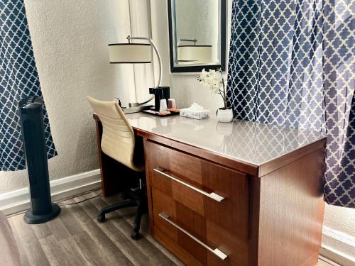a room with a desk with a lamp and a mirror at Admiral Hotel in San Francisco