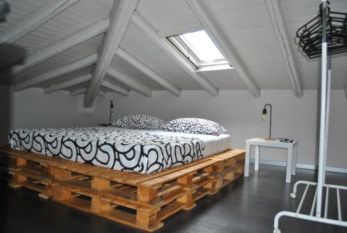 a bedroom with a bed on a wooden platform at La Terrazza dell’ODEON in Catania