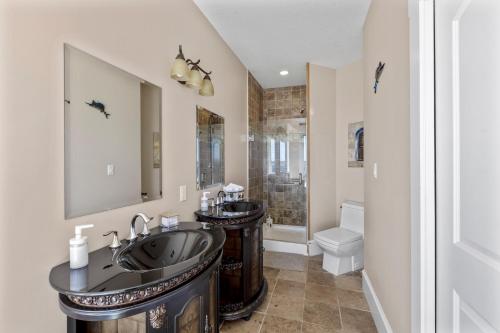 a bathroom with two sinks and a shower at Seaview Executive Home in Ladysmith