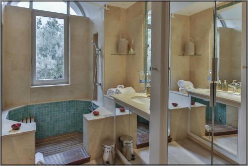 a bathroom with two sinks and a shower at VataFinca villa in Sant Josep de sa Talaia