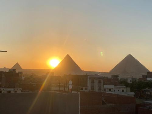 a view of the pyramids of giza at sunset at Horus pyramids Palace in Cairo