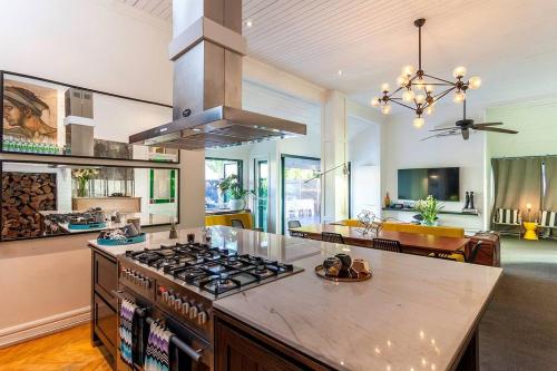 a kitchen with a stove top oven in a room at STUNNING TROPICAL OASIS free parking in Brisbane
