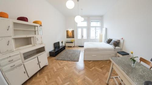 a white living room with a couch and a table at NewSunny Apartment at the BudaCastle in Budapest