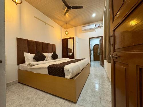 a bedroom with a large bed in a room at Candolim beach touch flats in Candolim