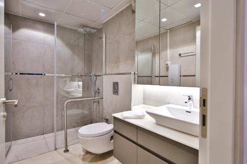 uma casa de banho com um WC, um lavatório e um chuveiro em MENE SUITES em Antalya