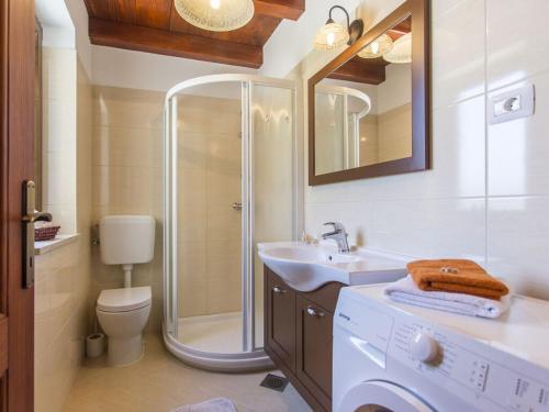 a bathroom with a shower and a sink and a toilet at Casa Mia Comfortable holiday residence in Barban