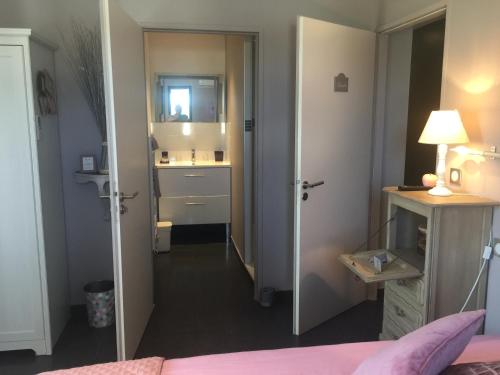 a bedroom with a bed and a sink and a mirror at Villa Louancelie B&B in Cavalaire-sur-Mer