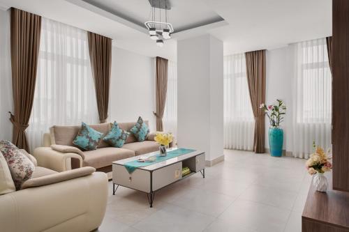 a living room with two couches and a coffee table at Queen Mansion in Phnom Penh