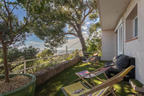 a balcony with chairs and a view of the ocean at 3 bedroom artist's house with AC, spectacular sea view - Dodo et Tartine in Toulon