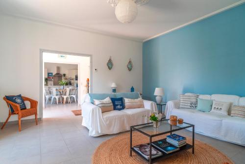 un salon avec un canapé et une table dans l'établissement Les Myosotis - Maison typique pour 12, à Clohars-Carnoët