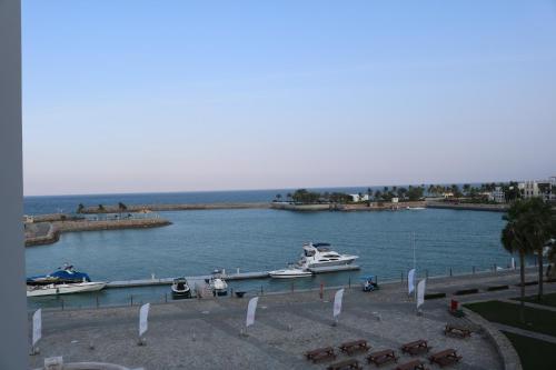 a large body of water with boats in it at Jabal Sifah Tha Marina View Apartment in Muscat