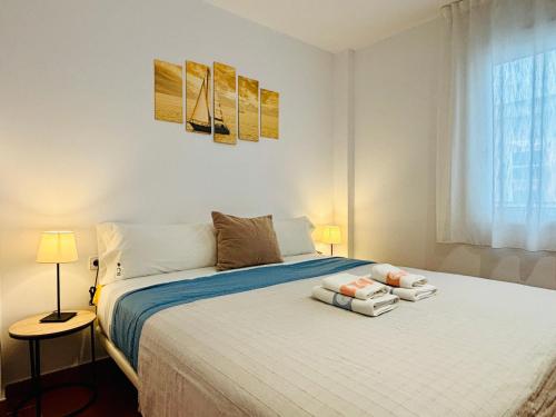 a bedroom with a bed with two towels on it at Apartamentos Plus Costa Brava Pals in Pals