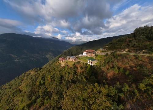 a house on the side of a mountain at Willing Resort, Trongsa in Kagha