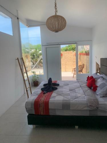 a bedroom with a large bed and a large window at Gili Davidoff Upstairs Budget And Deluxe in Gili Trawangan