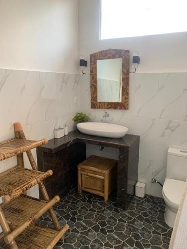 a bathroom with a sink and a mirror at Gili Davidoff Upstairs Budget And Deluxe in Gili Trawangan