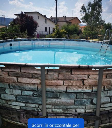 a large swimming pool in a brick wall at Villa La Pineta in Umbertide