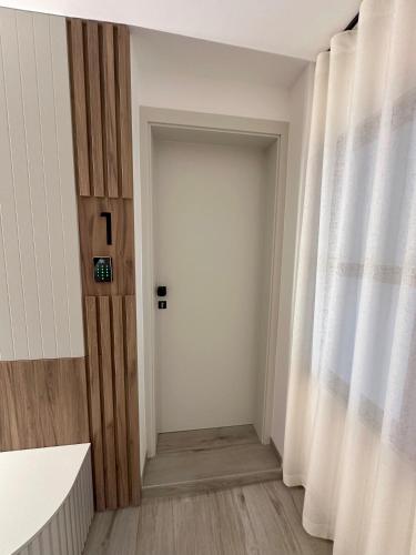 a hallway with a white door and a window at Žigon Bed & Breakfast in Logatec