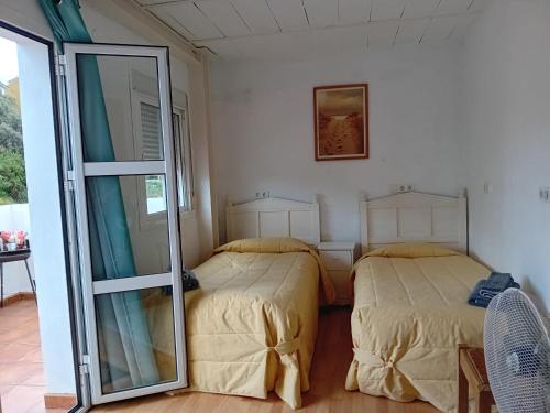 a bedroom with two beds and a mirror at Casita Tolox in Tolox