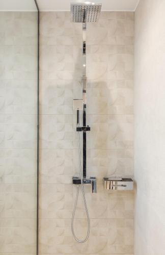 a shower with a shower head in a bathroom at Nostos Suites in Kourouta