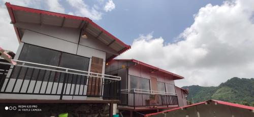 a building with balconies on the side of it at Dhanolti Resort in Dhanaulti