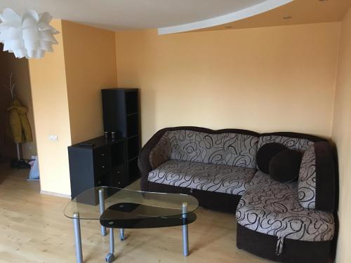 a living room with a couch and a glass table at Apartment on the 4th floor in Jūrmala