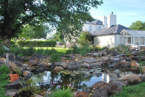 a pond in the yard of a house at Islay House - Blue Room in Woodend