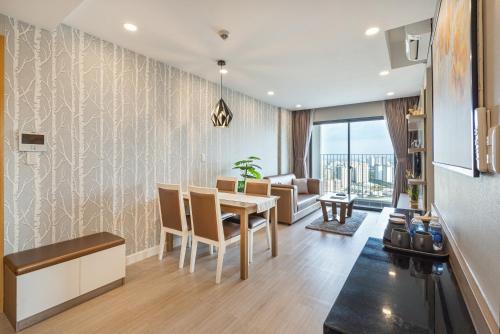 a dining room and living room with a table and chairs at The Potato Apartment in Ho Chi Minh City