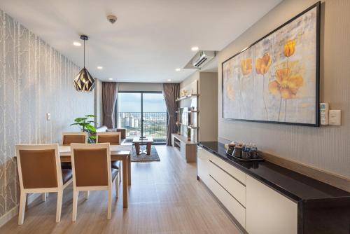 a kitchen and dining room with a table and chairs at The Potato Apartment in Ho Chi Minh City