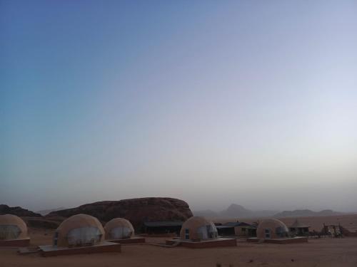 a group of domes in the middle of the desert at Wadi Rum Maracanã camp in Wadi Rum
