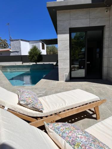 two beds on a patio next to a swimming pool at Shome in Vilanova i la Geltrú