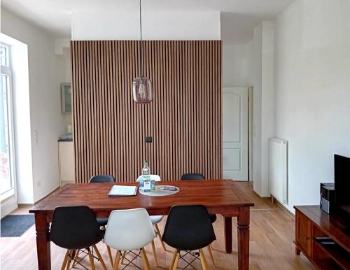 a dining room with a wooden table and chairs at Seehaus Plön in Plön